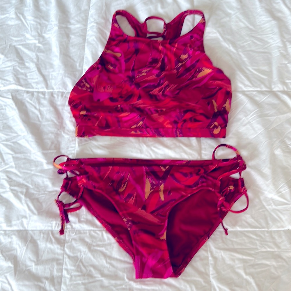 Almost new red bikini. Cross tied on the back and on the side of bottoms.
